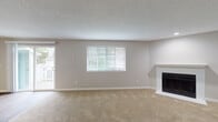 Located at 604 SE 121st Ave in Vancouver, Washington, this single-floor residence offers a clean, neutral aesthetic throughout its well-organized layout. The spacious living room serves as the heart of the home, featuring plush carpeting, a classic fireplace with a white surround, and a large window fitted with blinds that invites abundant natural light. A sliding glass door opens directly to an outdoor deck, providing a seamless indoor-outdoor connection with views of the surrounding greenery.

The kitchen is appointed with crisp white shaker-style cabinetry, sleek gray countertops, and generous storage across both upper and lower cabinets. Wood-look flooring runs through the kitchen and hallway, adding warmth and continuity to the space.

A well-lit hallway connects the main living areas to the bedrooms, each of which features soft carpeting, neutral wall tones, natural light from windows with blinds, and textured ceilings. The bedrooms include closet access, offering practical storage solutions.

The bathrooms are finished with gray countertop vanities, white cabinetry with brushed nickel hardware, drop-in sinks, and wood-look tile flooring — presenting a tidy, cohesive design. Overall, the residence presents a bright, move-in-ready interior with consistent finishes throughout.