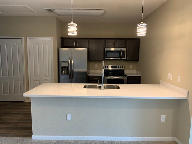 Kitchen, solid surface counter/ breakfast bar - 4966 Key Lime Dr Apartment