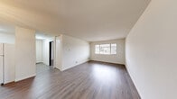 Located at 6172 S 31st St in Greenfield, Wisconsin, this one-bedroom, one-bathroom unit offers a well-organized, single-floor layout designed for comfortable everyday living. The space features consistent wood-look flooring throughout, lending a cohesive and modern aesthetic to every room.

The living room serves as the heart of the unit, offering a generous open area filled with natural light from a large window that looks out to the surrounding neighborhood. Clean white walls and neutral tones create a bright, airy atmosphere throughout.

The bedroom is a comfortable, well-proportioned room with the same wood-look flooring and crisp white walls. A full-width double bi-fold closet provides ample built-in storage, making practical use of the available space. A ceiling vent ensures consistent climate control year-round.

The bathroom is thoughtfully appointed, featuring wood-look flooring that ties into the rest of the unit, a white vanity with cabinet storage, a full tub and shower combination with a striped curtain, and a large mirror. Dark-framed door trim adds a subtle contrast to the light interior palette.

A hallway connects the rooms and provides access to the unit's entry door. The overall design is clean, functional, and move-in ready, making this Greenfield unit a practical and attractive option.