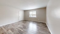 Located at 1700 Johnson Rd in Petersburg, Virginia, this one-bedroom, one-bathroom residence offers a practical and well-organized single-floor layout. The living room is a welcoming, open space finished with durable wood-look plank flooring in a neutral gray-brown tone, with natural light streaming in through a front-facing window. The kitchen is thoughtfully appointed with white shaker-style cabinetry, granite-look countertops, and stainless steel appliances including an electric range and over-the-range microwave. A dedicated pantry provides additional storage. The spacious bedroom features soft wall-to-wall carpeting, a window that brings in natural light, a closet, and direct hallway access. The bathroom includes a full tub-shower combination with a built-in surround, a toilet, and a mirrored medicine cabinet. Additional functional spaces include a hallway connecting the main areas, a utility room, and a closet for storage. Neutral wall tones are consistent throughout, creating a clean and cohesive aesthetic. The overall layout is efficient and straightforward, making excellent use of the available square footage to deliver a comfortable and complete living environment.