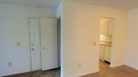 Located at 1523 E County Line Rd in Jackson, Mississippi, this single-floor unit offers a straightforward and functional layout designed for comfortable everyday living. The interior features clean white walls and neutral-toned flooring throughout, creating a bright and cohesive aesthetic. The entryway provides direct access into the living space, with a closet nearby offering convenient storage. A textured ceiling adds subtle dimension to the rooms. Adjacent to the main living area, the kitchen is visible and accessible, featuring white cabinetry, light countertops, and included appliances — offering an efficient and practical cooking space. The open sightlines between the entry, living area, and kitchen contribute to a sense of connectivity throughout the floor plan. Outlets and switches are positioned thoughtfully throughout, reflecting a practical approach to the unit's design. The overall ambiance is clean, neutral, and move-in ready, making it a versatile space suitable for a variety of living arrangements. Its single-floor configuration ensures ease of navigation, while the understated finishes provide a blank canvas for personalization.