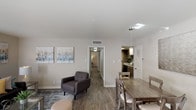 Located at 5445 S Alameda St in Corpus Christi, TX, this single-floor unit offers a well-designed, open-concept layout that connects the living, dining, and kitchen areas into a cohesive and functional living space. Wood-look flooring flows throughout, complementing the neutral, warm-toned walls that create a bright and welcoming ambiance.

The living room is generously sized, featuring large sliding glass doors that allow natural light to fill the space. A hallway connects the living area to multiple bedrooms, each equipped with ceiling fans and windows with blinds that allow for natural light and privacy. The bedrooms are spacious and well-proportioned, offering comfortable retreats with ample room for furnishings.

The kitchen is efficiently designed with dark cabinetry, granite-style countertops, tile backsplash, and black appliances including a range with overhead ventilation. It opens directly to the dining area, which is positioned near the front entry, making it ideal for entertaining. A separate flex room or den — visible in the layout — adds versatile living space, highlighted by a window and pendant lighting.

Throughout the unit, consistent finishes and a clean, modern aesthetic provide a cohesive look, making this Corpus Christi residence a practical and stylish place to call home.