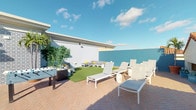 This inviting outdoor terrace is designed for relaxation and recreation, offering a thoughtfully organized layout that maximizes open-air enjoyment. The sun deck area features multiple cushioned lounge chairs arranged to take full advantage of natural sunlight throughout the day, ideal for unwinding in comfort. The terrace is finished with classic brick-patterned paving that adds warmth and character to the overall aesthetic.

A central patch of lush artificial turf provides a soft, green focal point within the space, flanked by casual seating and accent furniture. A foosball table positioned nearby adds an element of fun and social activity, making the terrace suitable for both leisure and entertainment. Potted bamboo and tropical greenery are strategically placed to introduce a natural, resort-like atmosphere.

The perimeter walls, finished in crisp white and accented with a bold teal feature wall, create a clean and modern architectural backdrop that enhances the brightness of the space. The open-sky ceiling allows for abundant natural light and an expansive feel.

Overall, this terrace presents a versatile outdoor environment that balances structured recreation with relaxed lounging, offering a well-rounded amenity space suited for social gatherings or quiet outdoor enjoyment.