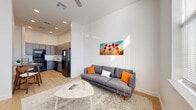 Located at 3525 N Peoria Ave in Tulsa, Oklahoma, this thoughtfully designed one-bedroom, one-bathroom unit offers a clean, contemporary aesthetic across a single floor. Light wood flooring runs throughout, complementing the bright white walls and creating a warm, cohesive feel.

The open living room is an immediate highlight, boasting soaring ceilings and oversized windows that flood the space with abundant natural light and offer pleasant outdoor views. The area provides a comfortable and airy atmosphere well-suited for everyday living.

The kitchen is both functional and stylish, featuring an extensive run of gray shaker-style cabinetry extending to the ceiling for generous storage, light quartz countertops, and a full suite of black appliances including a range, built-in microwave, dishwasher, and refrigerator. The adjacent dining area offers a seamless transition between cooking and dining.

The bedroom is a serene retreat with tall ceilings, large windows that invite natural light, and light wood flooring. Multiple closets provide practical storage throughout the unit. The bathroom is clean and modern, featuring a full tub-shower combination with crisp white tile and a sleek curtain rod. The unit is completed by a dedicated entrance and hallway, ensuring a well-organized and functional layout.