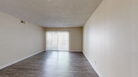 Located at 333 Van Gordon St in Lakewood, Colorado, this single-level 2-bedroom, 2-bathroom residence offers a well-organized layout across a comfortable footprint. The living room is a bright, open space featuring durable wood-style flooring, a textured ceiling, and a large sliding glass door fitted with vertical blinds that opens to a private balcony, allowing abundant natural light to fill the room. The adjacent dining room flows seamlessly from the living area, enhanced by a ceiling fan overhead. The kitchen is efficiently positioned to support the open living and dining space, as seen in the overhead floorplan view. Both bedrooms are carpeted for warmth and comfort, each featuring textured ceilings, windows with blinds for natural light and privacy, and closets for storage. The generously sized primary bedroom includes a spacious closet. Both bathrooms are finished with wood-style flooring, dark espresso-toned vanity cabinetry, stone-look countertops, and a shower-tub combination. A dedicated laundry area and hallway with additional closet space add practicality to the home. The warm neutral color palette throughout creates a clean, cohesive ambiance well-suited for a variety of living arrangements.