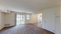 Located at 20 Church Rd in Maple Shade, NJ, this single-floor, 2-bedroom, 1-bathroom home offers a practical and comfortable layout across a well-utilized floor plan. The expansive living room is carpeted and bathed in natural light, anchored by a large sliding glass door that opens to outdoor views of a lush green yard, complemented by an adjacent window for additional brightness. A separate dining room flows naturally from the living area, providing a dedicated space for meals. The kitchen features warm wood-toned cabinetry, granite-style countertops, hardwood-style flooring, and a window overlooking the outdoors, creating an inviting cooking environment. Both bedrooms are carpeted and generously sized, each equipped with a closet — including double closet doors — and windows that allow natural light to fill the rooms. The primary bedroom offers a notably comfortable footprint with ample storage. The full bathroom is finished with neutral tile flooring, a white vanity with solid countertop, and a bathtub. Throughout the home, four closets provide excellent storage capacity, while two hallways connect the layout efficiently. The neutral color palette and clean finishes give the home a move-in-ready feel.