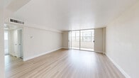 Located in Orlando's Lucerne Circle neighborhood, this 2-bedroom, 2-bathroom residence offers a thoughtfully laid-out single-floor plan. Light-toned hardwood flooring flows throughout the main living areas, creating a bright, cohesive aesthetic complemented by neutral walls and clean white trim.

The open combined living and dining area is the heart of the home, bathed in natural light from expansive floor-to-ceiling sliding glass doors that lead directly to a private patio, offering outdoor views and seamless indoor-outdoor connectivity.

The kitchen features white shaker cabinetry, light quartz countertops, a stainless steel sink, and stainless steel appliances including a refrigerator and dishwasher — a clean, functional space designed for everyday use.

The spacious primary bedroom is finished with plush carpeting, a ceiling fan with light fixture, and an en-suite bathroom. The bathrooms are finished in crisp white with tub-shower combinations, vanity mirrors with overhead lighting, and white cabinetry. A second bedroom, also carpeted, offers generous proportions.

Additional highlights include multiple closets for ample storage, a dedicated entrance, and a hallway connecting all rooms efficiently. The overall ambiance is light, clean, and move-in ready.