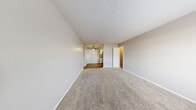 Located at 807 Cheyenne Blvd in Nashville, Tennessee, this two-bedroom, one-bathroom single-story home offers a practical and comfortable layout. The carpeted living room greets you at the front entry, where a paneled white door and a window allow natural light to fill the open space, creating a bright and welcoming atmosphere.

The galley-style kitchen is efficiently designed with white cabinetry, granite-style countertops, a double basin sink, and stainless steel appliances including a refrigerator and gas range, all set atop durable wood-look flooring. A hallway connects the main living areas to the two carpeted bedrooms, each featuring neutral-toned walls and windows that bring in natural light. The primary bedroom offers a comfortable footprint, while both rooms include access to dedicated closet storage.

The full bathroom is appointed with a tub-shower combination, wood-look flooring, a light wood vanity, and granite-style countertops. Additional functionality is provided by a utility room, offering practical storage or laundry space. Throughout the home, clean white trim, textured ceilings, and a consistent neutral color palette contribute to a cohesive and move-in-ready feel.