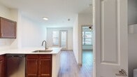 This 430 square foot apartment in Cool Springs offers a surprisingly spacious layout with two bedrooms and one bathroom. The primary bedroom measures 100 square feet, providing ample space for a comfortable retreat. Throughout the apartment, wood-look flooring adds warmth and durability to the space.

The modern kitchen is a highlight, featuring rich wooden cabinetry, stainless steel appliances including a refrigerator, oven, and built-in microwave. White subway tile backsplash complements the overall design, creating a clean and contemporary aesthetic.

Large windows and glass doors in the bedrooms and living areas flood the space with natural light, creating an airy and open atmosphere. Horizontal blinds offer privacy and light control. The bathroom, while compact, includes a full-sized bathtub with shower functionality, ensuring comfort and convenience.

The apartment's layout efficiently utilizes the available space, with a dedicated living room area and a closet for storage. Ceiling fans in the rooms provide additional comfort and air circulation. Despite its modest square footage, this apartment offers a well-designed living space with modern amenities and a bright, welcoming ambiance.
