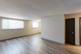 Located at 1200 Meadowview Dr in Marion, Iowa, this single-floor, 2-bedroom, 1-bathroom home offers a practical and comfortable layout. The open-concept living and dining area is finished with light-toned vinyl plank flooring and neutral walls, creating a bright, welcoming atmosphere. Multiple windows dressed with horizontal blinds allow natural light to flow throughout the space. A textured ceiling adds a classic touch to the main living areas.

The kitchen is efficiently designed with warm wood-toned cabinetry offering ample upper and lower storage, dark laminate countertops, a double-basin sink, and white appliances including a range, dishwasher, and refrigerator. The layout maximizes functionality within the space.

Both bedrooms feature plush carpet flooring, neutral wall tones, and windows that invite natural light. The spacious primary bedroom includes a closet with built-in wire shelving, providing organized storage. The second bedroom is equally comfortable with a similar design.

The bathroom is equipped with a full tub and shower combination, accented by classic white tile surround. Dark hardwood-style flooring and clean fixtures complete the space. Overall, the home presents a straightforward, well-maintained design suited for everyday living.