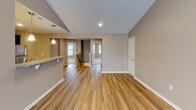 Located at 4720 Transit Rd in Depew, NY, this single-floor residence offers a well-designed layout with a cohesive blend of modern finishes and comfortable living spaces throughout.

The open-concept living and dining area is a highlight of the home, featuring warm hardwood-style flooring, vaulted ceilings, and a ceiling fan. Large windows and sliding glass doors allow natural light to fill the space, creating a bright and airy atmosphere. A peninsula counter with pendant lighting connects the living area to the kitchen, providing both functionality and visual appeal.

The kitchen is outfitted with rich dark cabinetry, granite countertops, and a full suite of stainless steel appliances, including a refrigerator, electric range, and over-the-range microwave. Light hardwood-style flooring continues throughout this area, complementing the overall design.

The bedrooms are carpeted and finished in warm neutral tones, each offering ceiling fans and windows that bring in natural light. The rooms provide generous space suitable for a variety of furniture arrangements.

The bathroom features a dark vanity with granite countertops, an undermount sink, and a large mirror, echoing the refined finishes found throughout the rest of the home. Hardwood-style flooring extends into this space as well, maintaining design consistency. Overall, the residence presents a clean, move-in-ready aesthetic.