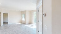 Located at 985 N Maple Grove in Boise, Idaho, this single-floor unit offers a clean, well-organized layout designed for comfortable everyday living. The interior is finished with light wood-tone luxury vinyl plank flooring that runs consistently throughout the main living areas, contributing to a cohesive and airy aesthetic.

The living area is generously sized and flooded with natural light through large windows and a sliding glass door that opens to a balcony, offering views of surrounding greenery. The neutral, warm-toned walls complement the light flooring and create a bright, welcoming atmosphere. A wall-mounted thermostat and ceiling-integrated fixtures reflect practical, functional detailing throughout.

The kitchen is efficiently arranged and features light maple cabinetry, a white electric range, a full-size refrigerator, and a range hood. A pantry closet adjacent to the kitchen provides additional storage.

The bathrooms are finished with warm wood-tone flooring, light maple vanity cabinetry, single-basin sinks, large mirrors with overhead lighting, and chrome hardware accents. The layout provides a dedicated water closet for added privacy.

Additional rooms benefit from ample natural light via well-placed windows, and built-in shelving is visible in select areas, offering practical storage solutions. The overall design is clean, neutral, and move-in ready.