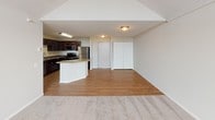 This well-appointed two-bedroom, two-bathroom residence offers a thoughtfully designed single-floor layout with generous living space throughout. The open-concept kitchen and living area serves as the heart of the home, where light hardwood-style flooring flows beneath a functional kitchen equipped with dark espresso cabinetry, stainless steel appliances including a gas range, microwave, refrigerator, and dishwasher, and a granite-topped peninsula that provides additional prep and seating space. The adjacent living area features plush carpeting and a sliding glass door dressed with vertical blinds, offering access to the outdoors and filling the space with natural light.

Both bedrooms are carpeted and generously sized, with the primary suite showcasing a vaulted ceiling with an arched window that draws in abundant natural light, creating an airy, elevated atmosphere. Each bedroom includes convenient access to a full bathroom. The bathrooms are finished with granite countertops, undermount sinks, white cabinetry, and tile flooring, with the primary bath featuring a dual-sink vanity. Neutral tones throughout the residence create a clean, cohesive aesthetic.
