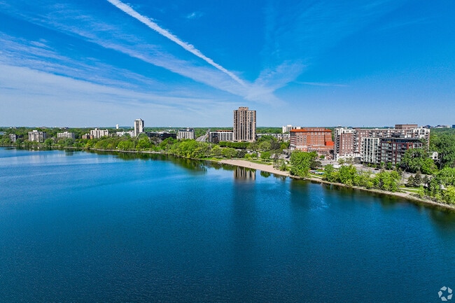 Apartment buildings rise next to the lake.