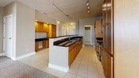 Located at 4437 Glengarry Dr in Beavercreek, Ohio, this single-floor home offers a thoughtfully designed layout with a mix of elegant architectural details and practical living spaces. The standout feature is a generously sized curved living area, defined by a sweeping arc of windows that flood the room with natural light and offer outdoor views. A tray ceiling with a central pendant fixture adds a refined architectural touch to this distinctive space.

The kitchen is well-equipped for everyday living and entertaining, featuring rich warm-toned cabinetry, dark granite countertops, a central island with a sink, and track lighting overhead. An adjacent built-in cabinetry nook provides additional workspace and storage, while large-format tile flooring ties the area together cleanly.

The bedrooms are carpeted in neutral tones and feature warm beige walls, providing a comfortable and cohesive feel throughout. Several rooms include closets and windows with blinds that allow for controlled natural light. One bedroom benefits from a particularly bright corner window arrangement.

The primary bathroom is spacious, offering a walk-in glass-enclosed shower, a soaking tub, tile flooring, and warm wood vanity cabinetry. A secondary bathroom features a tub-shower combination with tile flooring and matching cabinetry. Together, the spaces reflect a consistent, understated aesthetic suited for comfortable residential living.