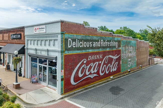 Colorful historic murals, like this Coca-Cola ad, are found on the sides of Acworth buildings.
