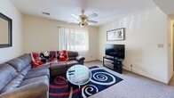 Located at 801 Lucinda Ave in DeKalb, Illinois, this single-floor 2-bedroom, 2-bathroom unit offers a practical and well-organized layout. The living room serves as the central gathering space, featuring carpet flooring, a ceiling fan with light fixture, and a large window with vertical blinds that allows natural light to fill the room comfortably. The kitchen is fully equipped with white cabinetry, a full suite of white appliances including a refrigerator, electric range, microwave, and dishwasher, complemented by light wood-tone flooring and a butcher block dining table with seating. The primary bedroom is generously sized, offering carpet flooring, a window with natural light, and ample space for a full bedroom set. The second bedroom is similarly appointed with carpet, a window, and a closet. Both rooms share a clean, neutral aesthetic. The two bathrooms feature wood-look flooring, a tub-shower combination, granite-style countertops, and recessed lighting, providing a tidy and functional design. Throughout the unit, light-toned walls and warm wood accents on doors and trim create a cohesive and inviting atmosphere.