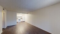Located at 3230 East Roosevelt Street in Phoenix, Arizona, this single-floor residence offers a practical and well-organized layout with two bedrooms and two bathrooms. Dark hardwood-style flooring flows consistently throughout the entire unit, providing a cohesive and clean aesthetic.

The living room is an open, bright space featuring a textured ceiling and a large window with vertical blinds that allows natural light to fill the room. It connects seamlessly to the kitchen, which is equipped with white cabinetry, dark laminate countertops, a white electric range, refrigerator, and a double-basin sink — offering a fully functional cooking space.

Both bedrooms are comfortably sized, each featuring windows with vertical blinds that bring in natural light and textured ceilings consistent with the rest of the unit. The primary bedroom is notably spacious and is supported by a dedicated closet with built-in shelving and hanging rods for organized storage.

The two bathrooms are efficiently designed, each featuring a tub-shower combination, toilet, and a vanity with countertop space and under-sink cabinetry. The unit also includes a hallway that connects the main living areas, contributing to an efficient and straightforward floor plan throughout.