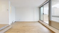 Located at 2100 Boulevard De Maisonneuve Ouest in Montréal, this studio offers a well-planned single-floor layout that makes efficient use of its space. Light wood laminate flooring runs throughout the unit, creating a warm and cohesive feel from the entrance hallway to the living areas.

The main living area is the centerpiece of the studio, characterized by expansive floor-to-ceiling windows that flood the space with natural light and frame elevated views of the surrounding Montréal cityscape. A sliding glass door provides direct access to a private balcony, further enhancing the open and airy atmosphere. A wall-mounted climate control unit ensures year-round comfort. A second living area offers additional flexibility, featuring the same light flooring and crisp white walls, suitable for use as a sleeping area or home office.

The entry corridor includes a built-in closet with shelving, offering practical storage. The bathroom is finished with classic white square wall tiles and mosaic floor tiles, and includes a floating vanity with under-sink storage, a mirrored medicine cabinet, and a glass-enclosed shower stall — all maintaining a clean, functional aesthetic.

Overall, the studio presents a bright, neutral palette with a modern sensibility, well-suited for urban living in the heart of Montréal.