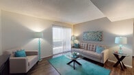 Located at 7730 E Broadway Blvd in Tucson, Arizona, this single-floor residence offers a thoughtfully designed layout that balances comfort and functionality throughout its living spaces.

The living room serves as the heart of the home, featuring rich wood-look flooring, a textured ceiling, and a large sliding glass door dressed with vertical blinds that floods the space with natural light and provides access to an outdoor area. The open sightline connects seamlessly to the dining area, creating an inviting, cohesive atmosphere.

The dining area is defined by built-in shelving along one wall, ideal for display or storage, and is illuminated by an overhead pendant light. The space comfortably accommodates a glass-top dining table and upholstered seating.

The kitchen is equipped with dark wood cabinetry, light countertops, a stainless steel sink, and black appliances including a gas range and dishwasher. A doorway leads conveniently to an adjoining utility or storage area.

The bedrooms feature plush carpeting, neutral-toned walls, and a textured ceiling. One bedroom benefits from a window with natural light, while both offer a calm, restful ambiance.

The bathroom includes a full tub-shower combination, a toilet, and a vanity with a light countertop, all set on wood-look flooring. A consistent teal and neutral color palette ties the entire residence together cohesively.