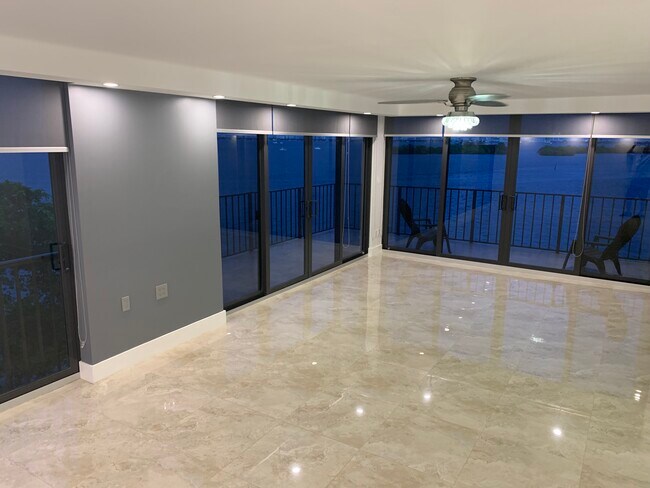 Spacious Living room has wrap around terrace with 180 degree views of Sunny Isles to Downtown Miami - 7751 NE Bayshore Ct