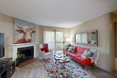 Located at 10474 Spaulding St in Omaha, Nebraska, this single-floor, 2-bedroom, 1-bathroom residence offers a well-organized layout across a comfortable footprint. The living room serves as the heart of the home, anchored by a classic fireplace with a white mantle and a sliding glass door that fills the space with natural light and provides outdoor access. The galley-style kitchen features warm oak cabinetry, white countertops, a double basin sink, a dishwasher, and electric range, with tile flooring that transitions neatly from the adjacent dining area. The dining room enjoys a window with natural light and provides an intimate setting for meals. The generously sized primary bedroom includes a large sliding-door closet with wire shelving, offering ample storage, while the second bedroom features plush carpet, a sizable window with natural views, and additional storage. The full bathroom is fitted with a tub-shower combination, tile flooring, and a vanity with storage. A dedicated walk-in closet with dual wire shelving racks adds to the functional storage capacity of this residence. Neutral warm-toned walls and carpeted living areas create a cohesive and welcoming ambiance throughout.