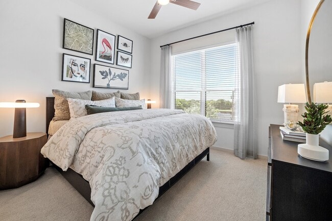 Experience ultimate relaxation in this stylishly designed bedroom filled with natural light. - The Emory