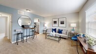 Located at 5618 Eunice Drive in Richmond, VA, this one-bedroom, one-bathroom unit is thoughtfully laid out across a single floor. The living room features neutral carpet flooring, soft blue accent walls, and a bright window that invites natural light, creating a welcoming and open atmosphere. It flows seamlessly into the galley-style kitchen, which is equipped with white cabinetry, dark countertops, a stainless steel refrigerator, range, and dishwasher, all complemented by warm wood-look vinyl flooring. The spacious bedroom features plush carpet, soft neutral walls, and a generous window offering outdoor views, providing a calm and restful retreat. A dedicated closet offers practical storage within the bedroom area. The bathroom includes a full tub-shower combo with classic white subway tile surround, wood-look flooring, and clean white fixtures. A hallway connects the living spaces efficiently, contributing to the unit's functional flow. The overall design balances comfort and practicality, with consistent neutral tones and modern finishes throughout, making it a well-appointed home in the Richmond area.