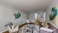 This single-floor home offers a practical and well-organized layout accommodating four bedrooms and two full bathrooms. Throughout the space, wood-look flooring in warm tones provides a cohesive and durable foundation, complemented by cool light-gray walls that create a calm, neutral atmosphere.

The living room is a welcoming space, filled with natural light from a front-facing window. It features ample room for seating and opens via a hallway to the rest of the home. Adjacent to the living area, the dedicated dining space features chair-rail molding and provides a cozy setting for meals.

The kitchen is efficiently designed with white shaker-style cabinetry, granite-look countertops, a subway tile backsplash, and a full suite of stainless steel appliances including a gas range, dishwasher, and refrigerator. A secondary door in the kitchen provides additional access.

The four bedrooms are well-proportioned, with the primary bedroom offering a generous footprint, a large window with natural views, and hardwood-style flooring. Additional bedrooms include sliding-door closets, providing practical storage. Both bathrooms are finished with white vanities, granite-look countertops, and tub-shower combinations, maintaining a clean and consistent aesthetic throughout.