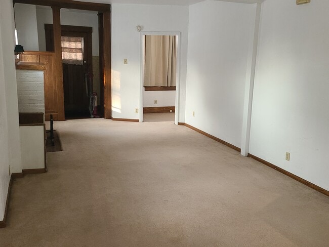 Looking towards front door. Fireplace on left. - 122 Edgerton Rd