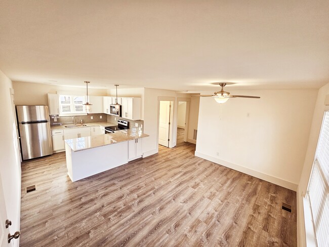 Large kitchen with granite countertops. There is storage on both sides of the island. - 1219 N 7th St