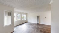 Located in Cerritos, CA, this well-appointed 1-bedroom, 2-bathroom single-floor unit offers a thoughtfully designed layout that maximizes every inch of its compact footprint. Throughout the home, wood-style flooring in warm gray tones provides a cohesive and modern aesthetic.

The bright living room features large windows that invite abundant natural light and offer views of the lush greenery outside. A textured ceiling and wall-mounted heating unit complete the space. The adjoining dining area and kitchen are a standout highlight—white shaker cabinetry, granite countertops, a mosaic tile backsplash, and a full suite of stainless steel appliances, including a gas range, built-in microwave, and refrigerator, create a polished and functional cooking space.

A clean hallway with wood flooring connects the main living areas to the private bedroom, which features a ceiling fan with light fixture, a mirrored sliding-door closet, and direct access to the private patio through sliding glass doors—ideal for indoor-outdoor living. The two bathrooms are finished with clean white fixtures, including a shower/tub combo with sliding glass doors. Crown molding accents the living and bedroom areas, adding a refined touch throughout.
