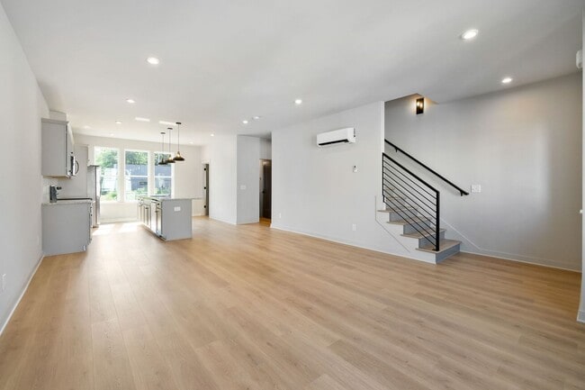 Building Photo - Captivating end unit townhome with covered...