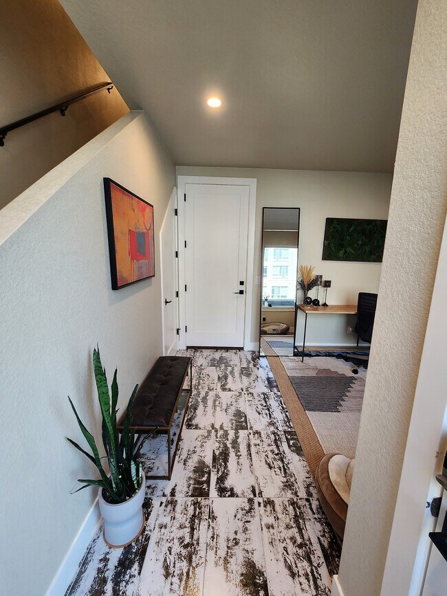 Entryway from front door: garage straight ahead, coat closet on the left, office space on right - 1581 Grove St
