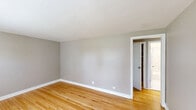 Located at 1310 Nottingham Way in Hamilton, NJ, this single-floor, 3-bedroom, 1-bathroom home offers a practical and well-maintained layout. Warm hardwood flooring flows consistently throughout the bedrooms and hallway, lending a classic character to the interior. Neutral gray walls provide a clean, versatile backdrop across the living spaces.

The spacious primary bedroom is the largest of the three, offering ample room for furnishings. All bedrooms are bright and simply appointed, with white trim and panel doors, and several feature windows that frame views of the surrounding greenery. One bedroom includes a built-in closet with shelving for added storage. Classic cast-iron radiators are present throughout, providing reliable radiant heat.

The kitchen features light vinyl flooring, warm gray walls, a gas range with a white subway tile backsplash, and a window that brings in natural light and exterior views. The full bathroom stands out with floor-to-ceiling marble-style porcelain tile surrounding a soaking tub, complemented by a frosted window for privacy and light. A connecting hallway ties all rooms together efficiently. This home combines timeless details with functional design in a convenient Hamilton location.