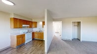 Located at 322 W 65th St in Davenport, Iowa, this single-floor, 2-bedroom, 1-bathroom residence offers a straightforward and functional layout well-suited for comfortable everyday living. The kitchen is equipped with warm honey-toned oak cabinetry, white appliances including an electric range and full-size refrigerator, a double-basin sink, and durable wood-look flooring. A partial wall separates the kitchen from the adjacent living area, which also features wood-look flooring and connects naturally to the hallway leading throughout the unit. Both bedrooms are carpeted in a neutral tone, providing a cozy feel, and each room is served by natural light through blinded windows. The primary bedroom includes a built-in closet with a hanging rod and shelf, while the secondary bedroom also features its own closet. The bathroom is finished with wood-look tile flooring, a white vanity with storage, and a full tub-shower combination. A central hallway ties all rooms together, creating a cohesive and easy-to-navigate flow throughout the home. Neutral wall tones and consistent finishes throughout contribute to a clean, move-in-ready appearance.