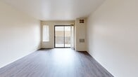 Located at Village Center Dr in Sacramento, CA, this single-floor, one-bedroom, one-bathroom residence offers a well-organized and efficient layout. The combined kitchen and living room forms the heart of the unit, featuring wood-style plank flooring that extends throughout the space. The living area is bright and open, with a sliding glass door that leads directly to a private patio, allowing natural light to fill the room and providing access to outdoor space.

The kitchen is thoughtfully equipped with warm oak-toned cabinetry extending to the ceiling for generous storage, granite-style countertops, a white refrigerator, dishwasher, and a gas range with overhead ventilation. A large ceiling-mounted light fixture ensures the workspace is well-lit.

The bedroom is a comfortable, well-proportioned room with a window that brings in natural light and a closet for storage. Neutral white walls throughout keep the space feeling clean and versatile.

The bathroom includes a single-sink vanity with wood cabinetry and a speckled countertop, a full bathtub and shower combination, and wood-style flooring. Additional features include two closets, a utility room, and a textured ceiling in the living area, rounding out this practical and neatly designed Sacramento residence.