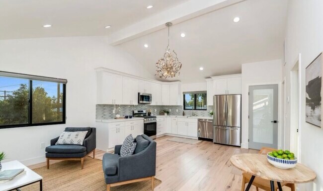 View of Living/Kitchen Area with View of Door to In-Unit Laundry(Right of Fridge) - 527 Groton Dr