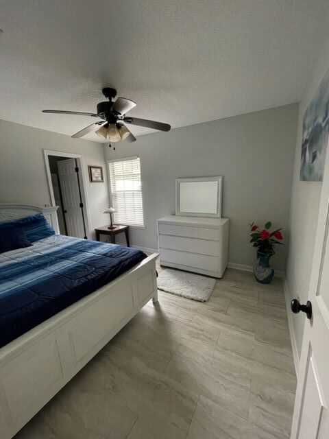 Bedroom with walk-in closet; furnished, includes bedding sheets, comforter, and pillows. - 7782 Pikes Peak Dr