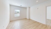 This contemporary apartment, located at 175 Rock Rd, Unit 1207 in Bergen, NJ, offers 830 square feet of well-designed living space. The single-floor layout comprises two bedrooms, two bathrooms, a combined kitchen and living area, and a hallway. The primary bedroom is generously sized at 170 square feet, providing ample space for relaxation and storage.

The heart of the home is the open-concept kitchen and living area. The kitchen boasts modern cabinetry in a warm wood tone, complemented by sleek stainless steel appliances and a striking marble-topped island. Light-colored subway tile backsplash adds a touch of elegance, while recessed lighting ensures bright, even illumination.

Throughout the apartment, light wood-look flooring creates a sense of warmth and continuity. Large windows in the bedrooms and living areas allow natural light to flood the space, enhancing the airy feel. The bathrooms feature contemporary fixtures, including floating vanities and glass-enclosed showers.

The apartment's neutral color palette, dominated by crisp whites and warm wood tones, provides a blank canvas for personal style. Recessed lighting throughout and strategically placed electrical outlets add to the overall functionality of the space. This well-appointed apartment offers a perfect blend of style and comfort for modern urban living.