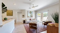 Located in Rancho Cucamonga, CA, this well-appointed one-bedroom, one-bathroom residence offers a cohesive and modern interior across a single floor. The living room serves as the heart of the home, featuring light wood-look flooring, crown molding, a ceiling fan, and a sliding glass door that opens to a private outdoor patio, filling the space with natural light and fresh air. The kitchen is efficiently designed with white shaker cabinetry, a neutral tile backsplash, stainless steel appliances including a range and refrigerator, and light countertops — offering both functionality and style. An additional cabinetry area provides generous storage and extra counter space. The bedroom is carpeted for comfort, with a large window that invites natural light and outdoor views, lending a calm, restful atmosphere. The bathroom features light wood-look tile flooring, a white vanity with ample storage, a well-lit mirror, and a clean, neutral palette throughout. A dedicated laundry area and closet add everyday convenience. The unit's warm, neutral tones and consistent modern finishes create a cohesive and inviting ambiance throughout.