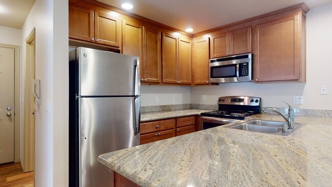 Stunning Kitchen with Stainless steel appliances, lots of counter space and cabinet storage, and a dining area. - Windsong