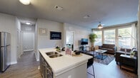 Located at 800 Basin St in Tallahassee, FL, this well-appointed 4-bedroom, 4-bathroom residence offers a thoughtfully designed single-floor layout. The open-concept kitchen and living area serves as the heart of the home, featuring a large center island with a double sink and white quartz countertops, two-tone cabinetry with white upper cabinets and dark lower cabinets, a tasteful tile backsplash, and a full suite of stainless steel appliances. Bar seating at the island connects seamlessly to the living area, where a ceiling fan, large windows, and natural light create a bright, welcoming atmosphere. Wood-look plank flooring flows consistently throughout the common areas and bedrooms, lending a cohesive, modern aesthetic. Each of the four bedrooms offers comfortable proportions, with the primary bedroom featuring a ceiling fan, a window with natural light, and an open closet with shelving. All four bathrooms follow a consistent design with dark vanity cabinetry, white countertops, framed mirrors, and shower/tub combinations with curtains. A dedicated laundry room houses a full-size washer and dryer. The layout is practical and efficient, with a hallway connecting the bedrooms and common spaces for a functional flow throughout the home.