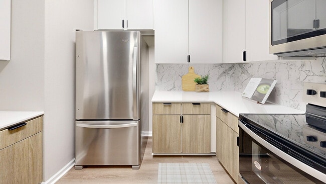 Spacious kitchen with stainless steel appliances - Waterstone at Big Creek Apartments