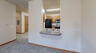 This 890 square foot apartment in Minneapolis offers a practical and efficient living space. The layout comprises two bedrooms, including a generous primary bedroom of 190 square feet, one bathroom, and two closets for ample storage. The single-floor design ensures easy navigation throughout the space.

The kitchen is a highlight, featuring modern appliances including a refrigerator and stove. Light wood cabinetry provides plenty of storage, while the countertops offer adequate space for meal preparation. A convenient pass-through window connects the kitchen to the living area, enhancing the open feel of the space.

The bathroom is well-appointed with a toilet, shower, and multiple grab bars for safety and accessibility. Tiled flooring in the bathroom contrasts with the soft carpeting found in the bedrooms and living areas, adding texture and warmth to the space.

Large windows in the bedrooms allow natural light to flood the rooms, creating a bright and airy atmosphere. The neutral color palette of white walls and light carpeting provides a blank canvas for personalization.

This apartment combines functionality with comfort, making it an ideal choice for those seeking a cozy urban dwelling in Minneapolis.