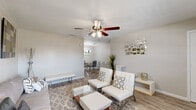 Located at 6419 Skyline Dr in Houston's 77057 corridor, this one-bedroom, one-bathroom home offers a thoughtfully designed single-floor layout with modern updates throughout. The living room is bright and welcoming, featuring wood-look flooring, a ceiling fan with light fixture, and a neutral color palette that creates an open, airy feel. It flows naturally into a dedicated dining area, making the shared space ideal for everyday living and entertaining. The galley-style kitchen is well-appointed with gray shaker cabinetry, white quartz countertops, stainless steel appliances, an arabesque tile backsplash, and durable wood-look flooring. The bedroom offers comfortable carpeting, a ceiling fan, natural light from a window with blinds, and a generously sized double-door closet. A dedicated vanity area with a marble-look quartz countertop and large mirror adds a refined touch. The bathroom features a glass-enclosed walk-in shower finished with large-format wall tile, mosaic hex floor tile, and a built-in niche — a clean, spa-inspired design. Multiple closets throughout the home provide excellent storage, and hallways connect each space efficiently. The overall ambiance is modern and clean, with consistent finishes that give the home a cohesive, well-maintained character.