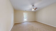 Located at 620 Dillon Trace St in Sumter, South Carolina, this single-story, 2-bedroom, 2-bathroom home offers a straightforward and functional layout designed for comfortable everyday living. Warm neutral tones and white trim carry consistently throughout, creating a cohesive and clean aesthetic across all rooms.

The kitchen is well-appointed with white shaker-style cabinetry, stainless steel appliances including a refrigerator, dishwasher, electric range, and microwave, plus light wood-look flooring and ample counter space. A hallway connects the main living areas to the bedrooms and bathrooms.

The living room is generously sized, featuring plush carpeting, a ceiling fan with light kit, and a glass door leading to an outdoor deck — bringing in natural light and outdoor views. Both bedrooms are carpeted and include ceiling fans; the spacious primary bedroom offers access to a closet, while the secondary bedroom features a window with blinds and its own closet access.

The two bathrooms are finished with wood-look flooring and white vanities. One includes a tub/shower combo, while the other features a walk-in shower stall. Both maintain the home's clean, neutral palette with brushed nickel hardware throughout.