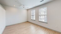 Located at 577 Meeting St in the heart of Charleston, SC, this efficiently designed single-floor unit offers a thoughtfully planned layout that maximizes every square foot. The open-concept living area features light-toned hardwood-style flooring that flows seamlessly throughout, complementing the clean white walls and recessed lighting that keep the space feeling bright and airy. A ceiling fan in the main living area adds both comfort and a modern touch, while two generously sized windows dressed with white blinds invite ample natural light.

The kitchen is a standout feature, designed with functionality and style in mind. It is equipped with warm wood-toned cabinetry, granite-look countertops, a white subway tile backsplash, and a full suite of stainless steel appliances including a range, microwave, dishwasher, and refrigerator — ideal for everyday cooking and entertaining.

The bathroom is equally well-appointed, showcasing a wood-toned vanity with a stone-look countertop, light tile flooring, and a full tub and shower combination surrounded by elegant marble-style tile surround. The overall aesthetic throughout this unit is clean, contemporary, and move-in ready, making it an excellent option in one of Charleston's most vibrant neighborhoods.