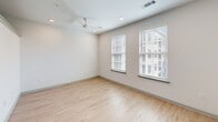 Located at 577 Meeting St in the heart of Charleston, SC, this efficiently designed single-floor unit offers a thoughtfully planned layout that maximizes every square foot. The open-concept living area features light-toned hardwood-style flooring that flows seamlessly throughout, complementing the clean white walls and recessed lighting that keep the space feeling bright and airy. A ceiling fan in the main living area adds both comfort and a modern touch, while two generously sized windows dressed with white blinds invite ample natural light.

The kitchen is a standout feature, designed with functionality and style in mind. It is equipped with warm wood-toned cabinetry, granite-look countertops, a white subway tile backsplash, and a full suite of stainless steel appliances including a range, microwave, dishwasher, and refrigerator — ideal for everyday cooking and entertaining.

The bathroom is equally well-appointed, showcasing a wood-toned vanity with a stone-look countertop, light tile flooring, and a full tub and shower combination surrounded by elegant marble-style tile surround. The overall aesthetic throughout this unit is clean, contemporary, and move-in ready, making it an excellent option in one of Charleston's most vibrant neighborhoods.