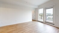 Located at 2515 Hackett Crescent in Saanichton, BC, this well-designed two-bedroom, one-bathroom unit offers a clean, modern aesthetic throughout. Light-toned laminate flooring flows seamlessly across the entire floor plan, complementing the crisp white walls and creating a bright, cohesive atmosphere.

The open-concept kitchen and living area forms the heart of the unit. The kitchen is thoughtfully appointed with flat-panel white cabinetry extending to the ceiling for ample storage, a subtle tile backsplash, light countertops, and a full suite of stainless steel appliances including a refrigerator, range, built-in microwave, and dishwasher. Recessed pot lighting illuminates the space efficiently. The adjacent living area benefits from a large glass door that opens onto a private balcony, inviting natural light and offering views of the surrounding landscape.

Both bedrooms are finished in the same neutral palette, with the primary bedroom featuring a set of sleek sliding closet doors. The second bedroom provides a comfortable, flexible space. The bathroom is clean and functional, finished with light tile flooring, a tub-shower combination with chrome fixtures, and a vanity with integrated storage. The overall design of this unit prioritizes a modern, move-in-ready feel with practical, durable finishes throughout.